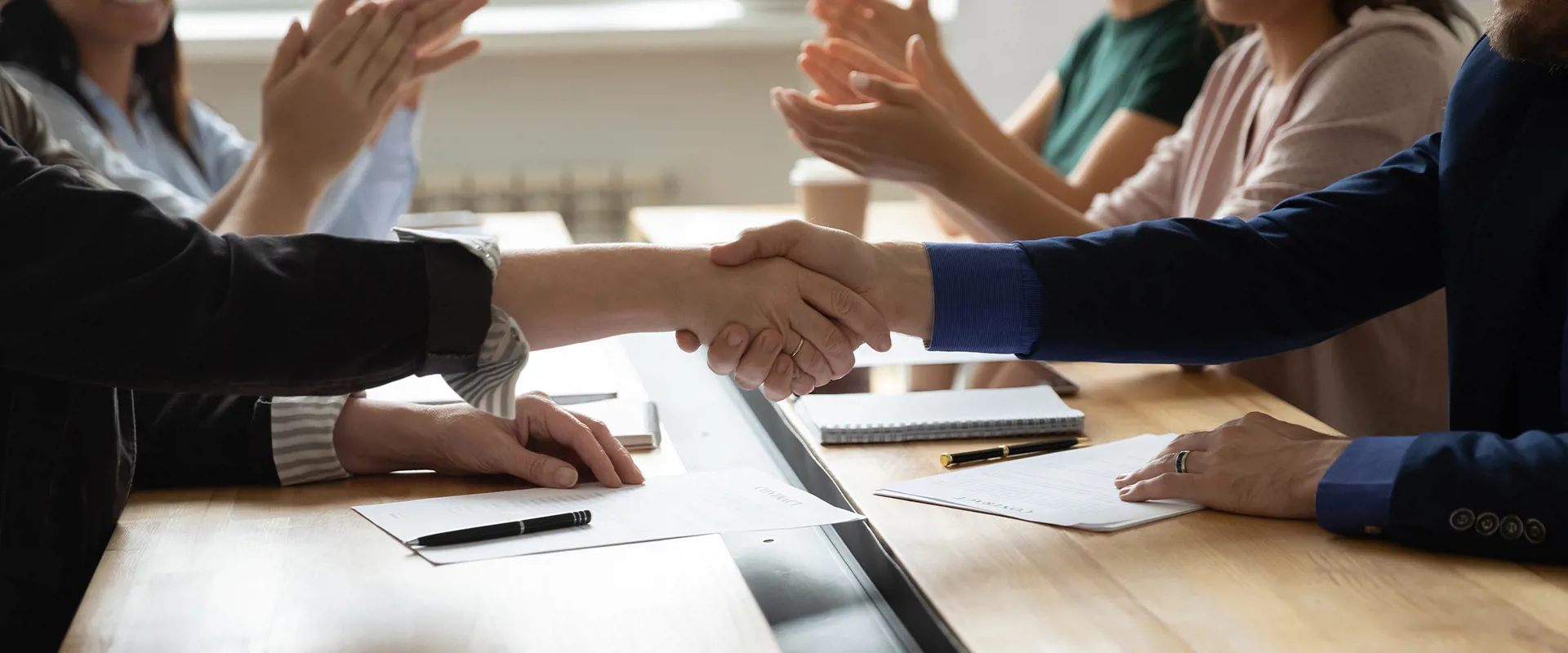 Government agency team shaking hands and working collaboratively in the office