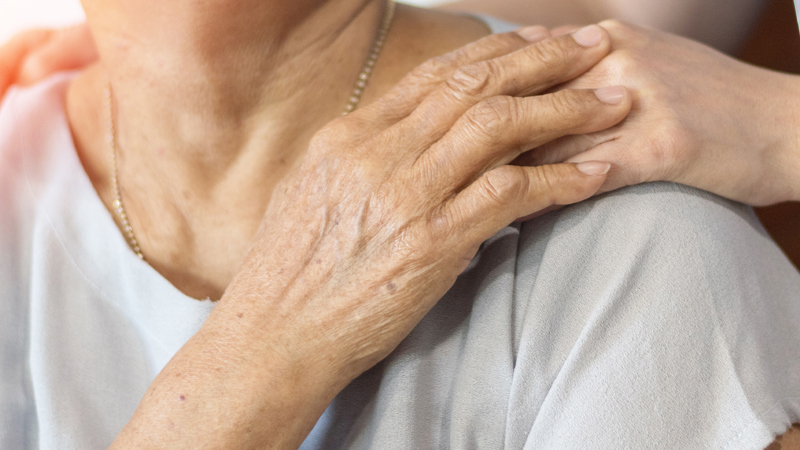 Healthcare professional supporting an elderly community member