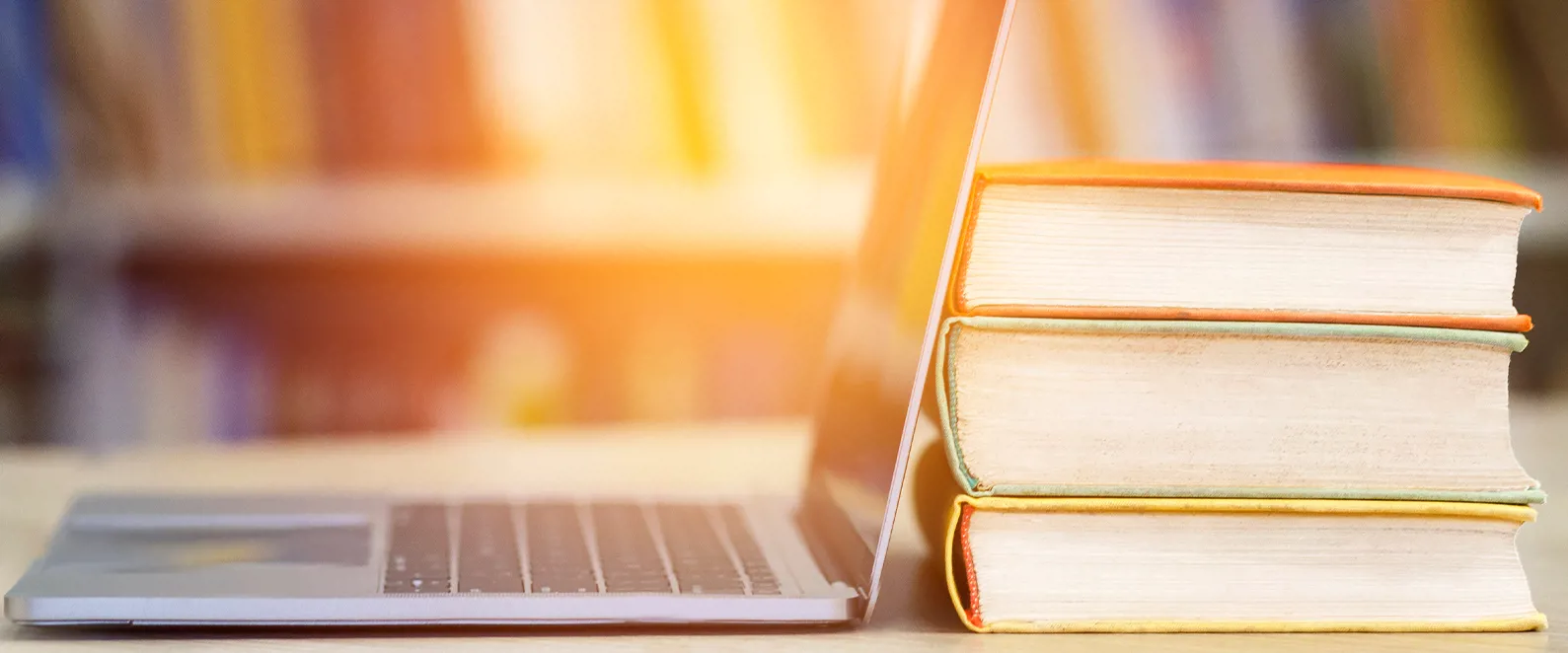 Books and a laptop laying on the desk