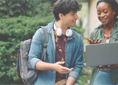 Two people smiling at a laptop