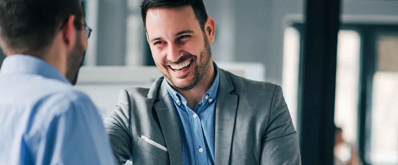 Friendly professionals talking and smiling in an office space