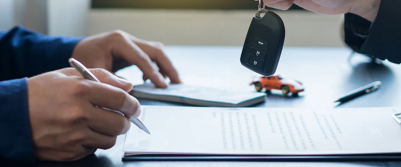 Customer signing vehicle leasing documents in the office