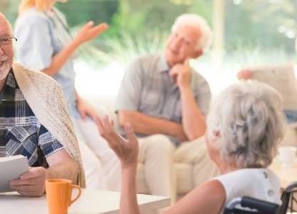 Care home residents having a conversation in a communal space
